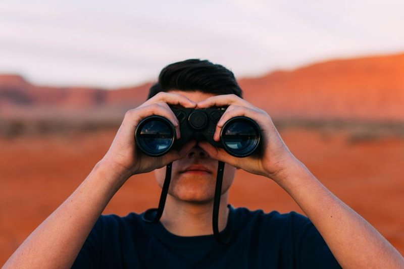 Person looking through binoculars
