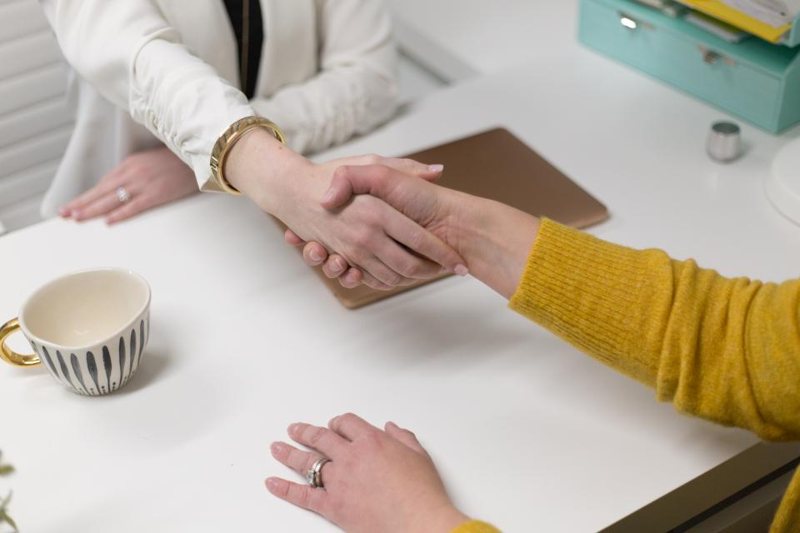 Business handshake across a desk