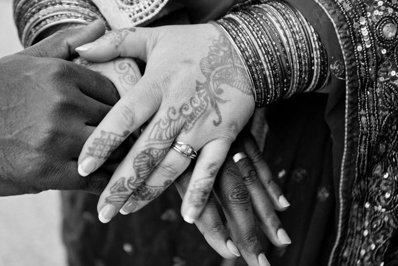 Hands with henna and wedding rings